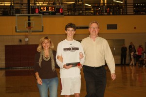 Photo by Anna Kaseff. Senior Matt Kavanaugh and his parents walk down the court during the ceremony.