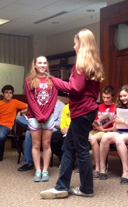 Photo by David Robinow. Freshman Alexis Davis gives a farewell speech to senior Kara Kahn.