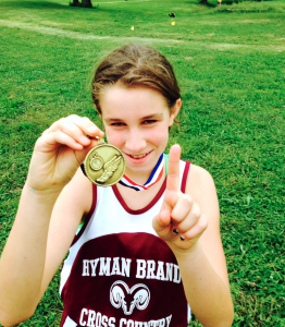 Photo by Tim Iseman. Fifth grader Ariel Iseman proudly shows off her gold medal.
