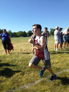 Photo by Elana Goldenberg. Freshman Jacob Bell gives his all as he finishes the race.