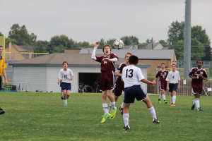 Photo by Alexis Davis. Eighth grader Josh Kriesler goes up for the ball.