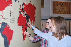 Senior Anna Kaseff (left) and junior Lindsey Paul study a map of Africa. Photo by Moriah Abrams