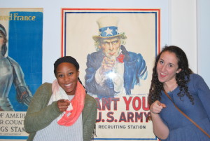 Juniors Ella Pavin (left) and Adena Goldberg pose in front of a poster in the museum. Photo by Moriah Abrams