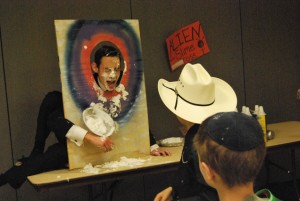 Sophomore Ariel Brudoley happily accepts a pie to the face as part of the Purim Carnival. Photo by Lauren Hassan.