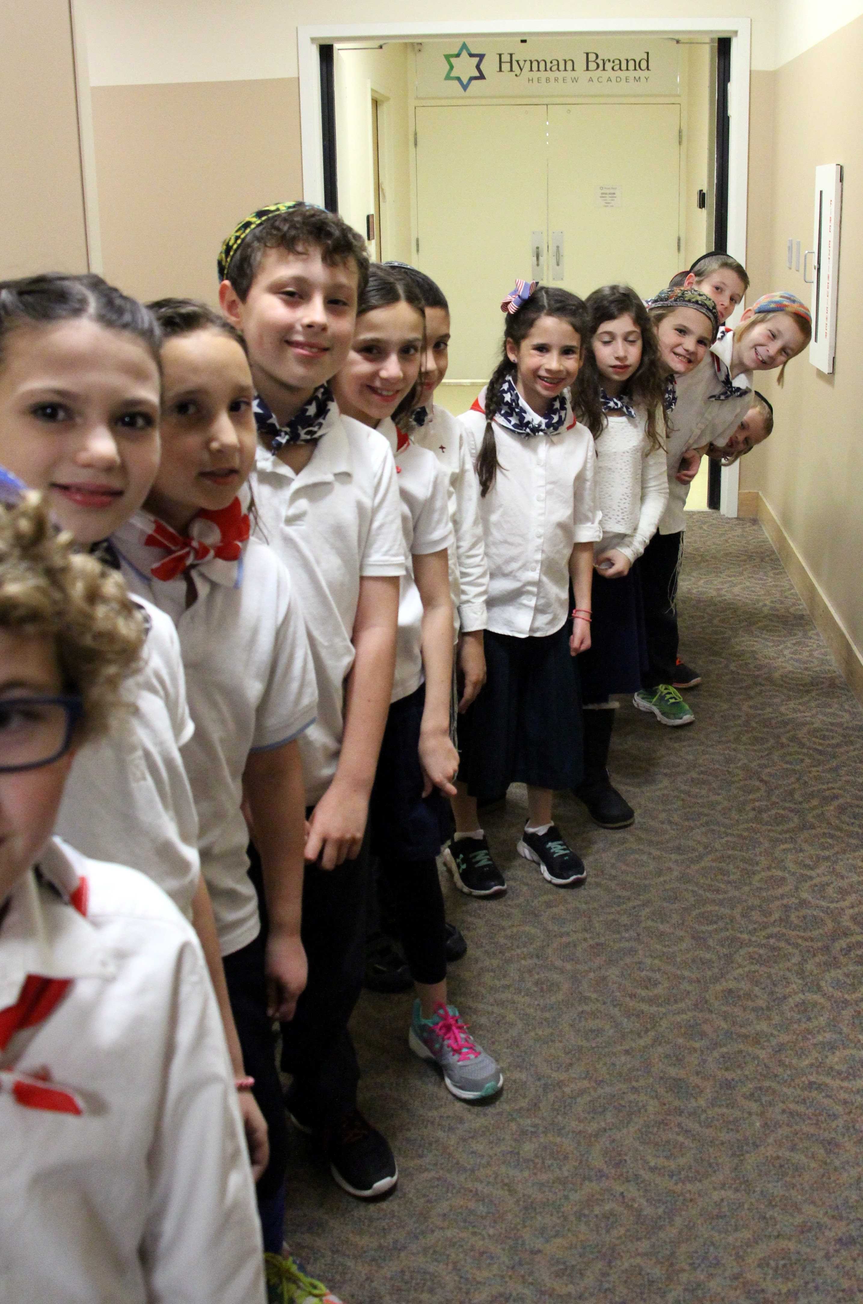 Fourth and fifth graders smiled excitedly as they prepared to enter the social hall for State Fair. Photo by Debi Davis.